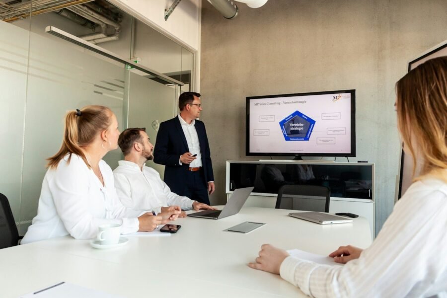 Business meeting with a presenter and colleagues in office.