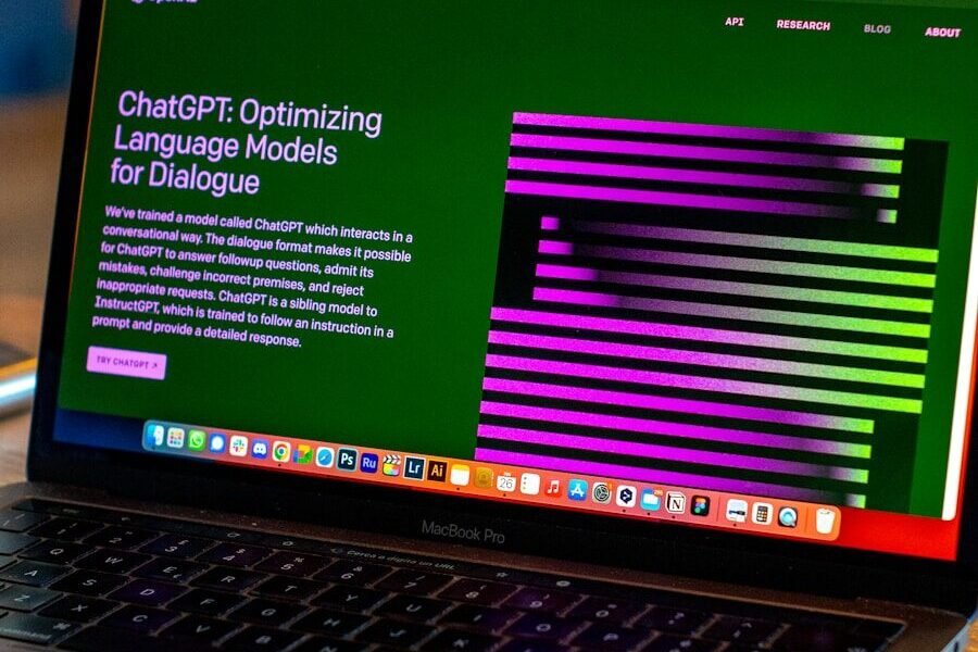 a laptop computer sitting on top of a wooden table